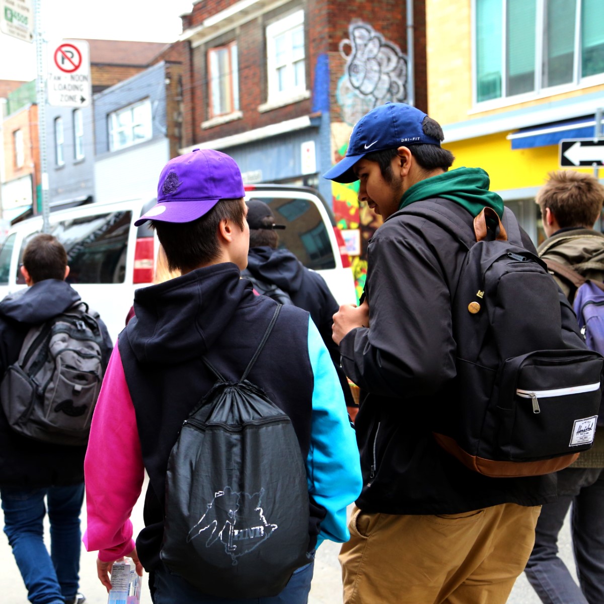 2 teen boys talking during Kensington market tour on Youth Exchanges Canada exchange. Photo by Sarah Cowan.